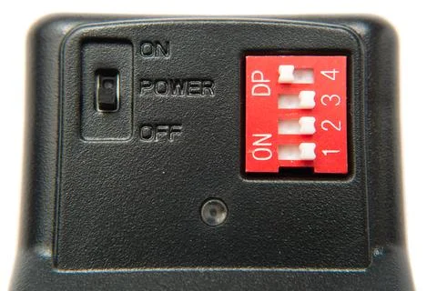 The button of the switch on a black device. On, off, power. Dp. White buttons Stock Photos