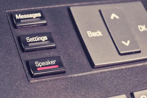 Button with text speaker, messages and setting on landline phone in office, c Stock Photos