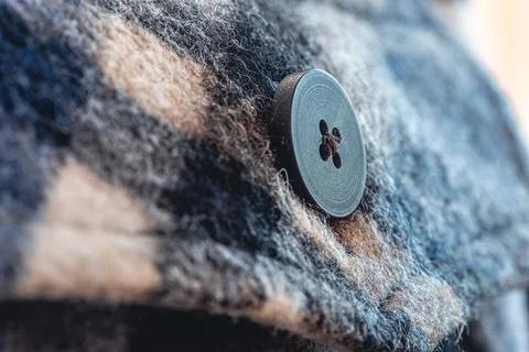 Button on a warm blue shirt, macro shot. Foto stock