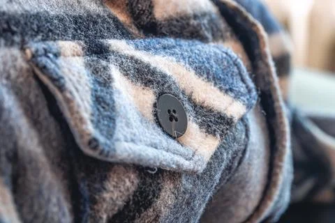 Button on a warm blue shirt, macro shot. Foto stock