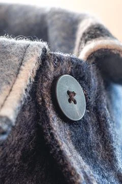 Button on a warm blue shirt, macro shot. Foto stock