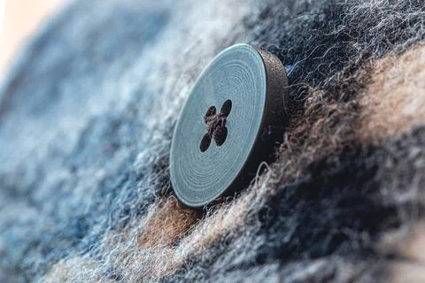 Button on a warm blue shirt, macro shot. Foto stock
