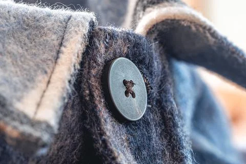 Button on a warm blue shirt, macro shot. Foto stock