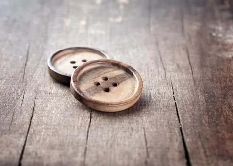 Button on a wooden table Stock Photos