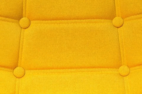 Buttoned yellow chair back support detail Stock Photos