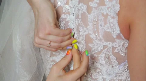 Buttoning on the bride's dress Stock Footage 40472221