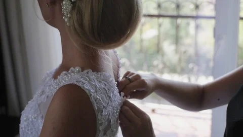 Buttoning bride's wedding dress. Close up. Stock-Footage 81936435