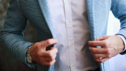 Buttoning jacket casual hands close up. Stylish well-dressed man arranges dress Stock Footage 71266587