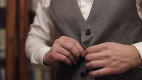 Buttoning jacket with hands close up, man in suit fastens buttons on his jacket Stock Footage 153715876