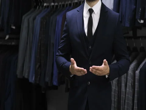 Buttoning a jacket. Stylish man in a suit Demonstration of touch screen hand Stock Footage 76899682