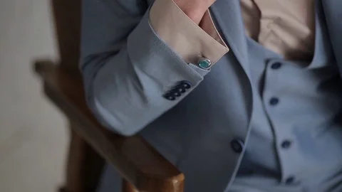 Buttoning a jacket. Stylish man in a suit fastening buttons on his jacket Stock Footage 83222972