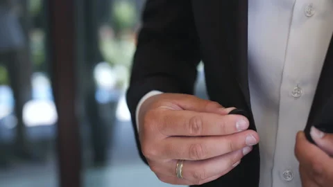 Buttoning a jacket. Stylish man in a suit fastening buttons on his jacket prepar Stock Footage 111805660