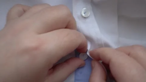 Buttoning a shirt in close-up. Stock Footage 333782427