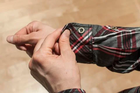 Buttoning the shirt's sleeve Stock-Fotos