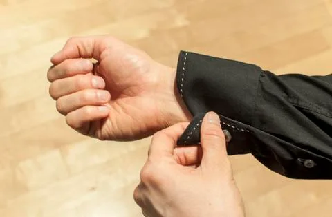 Buttoning the sleeve Stock Photos