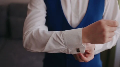 Buttoning a suit. Stylish man in a suit fastening buttons on his suit preparing Stock Footage 105092621
