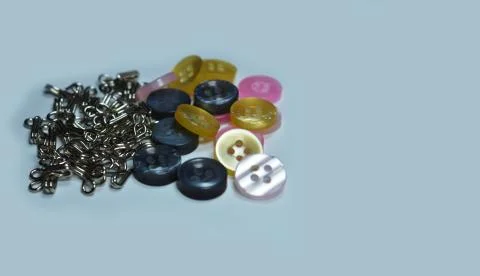Buttons and hooks on white surface. Some parts of the image are infocus. Repr Stock Photos