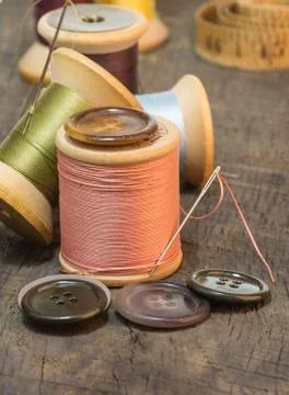 Buttons and needles with sewing thread Stock Photos