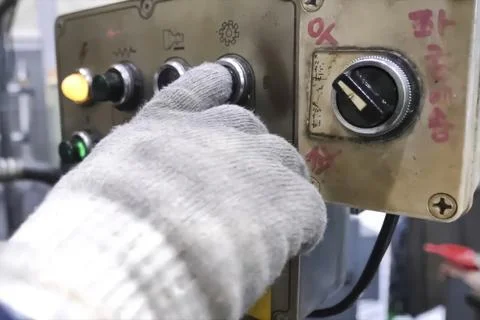 Buttons and switches on the control panel of machine elements, the hand in .. Stock Photos