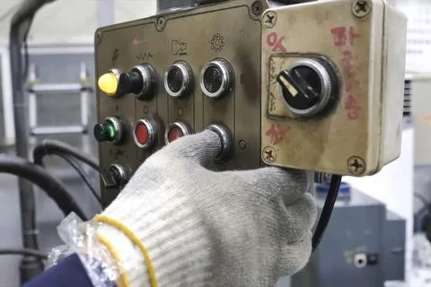 Buttons and switches on the control panel of machine elements, the hand in .. 스톡 사진