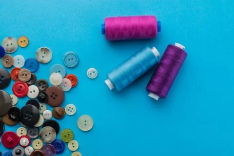 Buttons and thread on a blue background Stock Photos