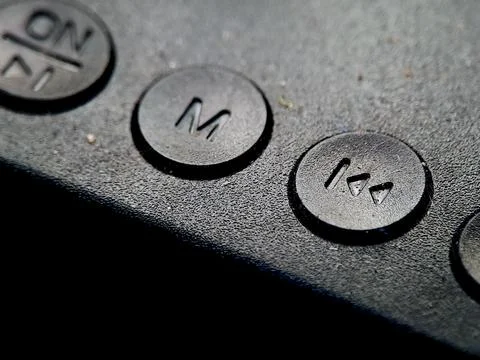 Buttons are presented in a dimly lit environment, casting shadows over its .. Stock Photos