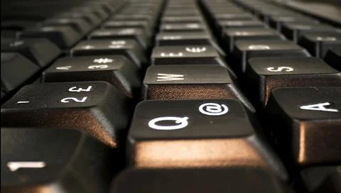 Buttons on a black keyboard close-up. Stock Photos