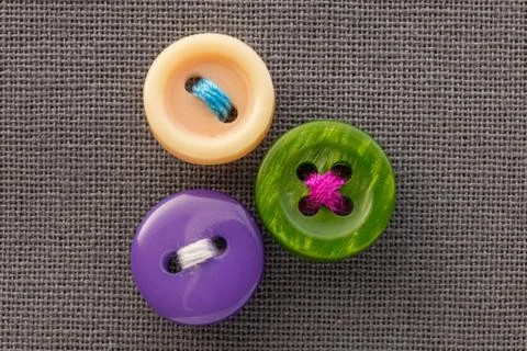 Buttons on gray fabric in macro Stock Photos