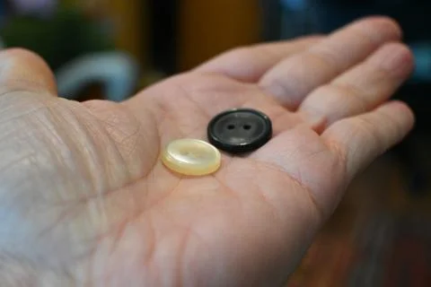 Buttons held in hand for mending clothes Stock Photos