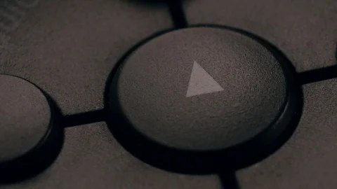 Buttons play, rewind, fast forward, stop. Angled macro shot. Slightly dark light Stock Footage 118597324