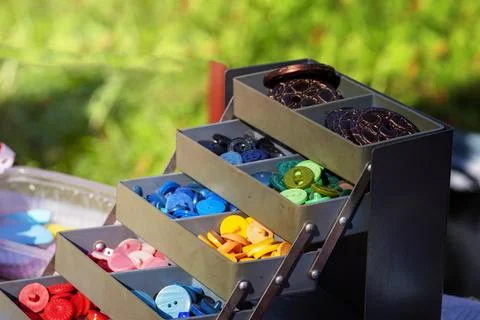 Buttons  set.  bookcase with colored buttons . Objects for sewing. close-up.. Stock Photos