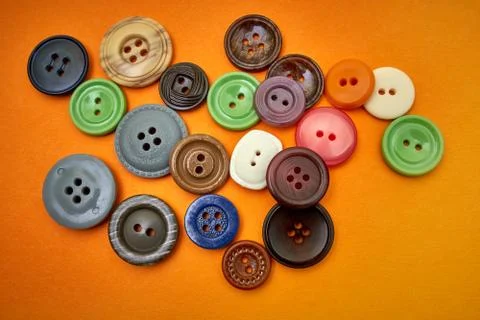 Buttons sewing on an orange background Stock Photos