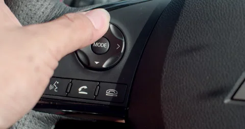 Buttons on the steering wheel for audio player controls. Stock Footage 310912171