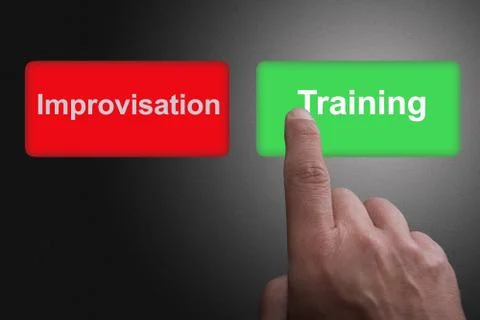 Buttons with written training and improvisation and pointing finger, on a gra 스톡 사진