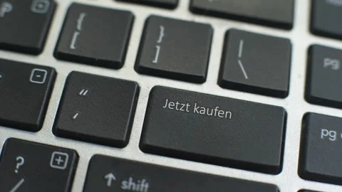 Buy now in German button on computer keyboard, female hand fingers press key Stock Footage 97828847