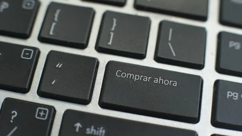 Buy now in Spanish button on computer keyboard, female hand fingers press key Stock Footage 97827992