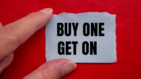 Buy One Get One message written on ripped torn paper background Stock Footage 317946440