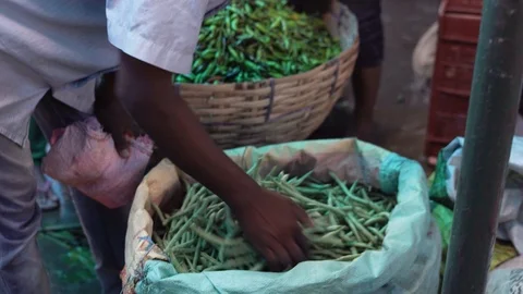 Buyer are checking the quality of beans with his hand in a local market in Stock Footage 110909771