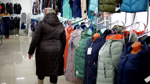 Buyer chooses jacket 2 Stock Footage 104659302