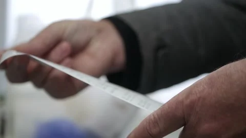 Buyer Getting Home from Store and Checking the Shopping Receipt. Man Checking Stock Footage 201028234