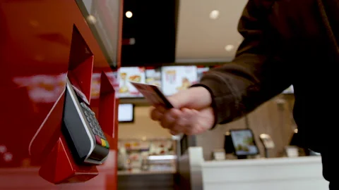 Buyer makes payment through a payment terminal with a credit card. Stock Footage 134700681