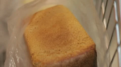 The buyer puts bread in the cart. Video stock 22244273
