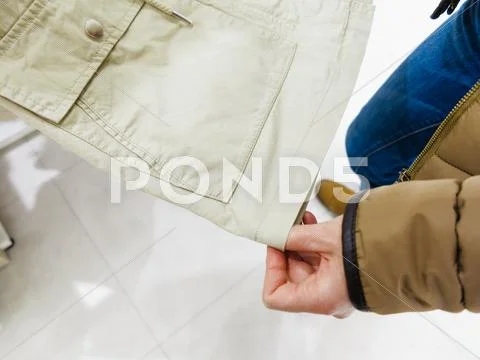 Buyer watching clothes in shop. Stock Photos
