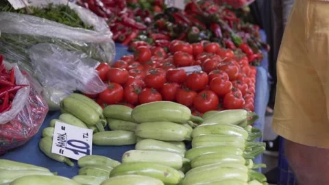 A buyer without a face buys vegetables at a farmer's market Stock Footage 234735555