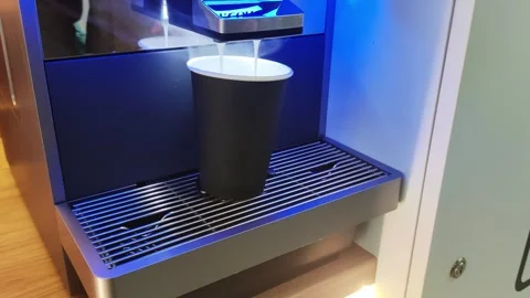 Buying and preparing coffee in a modern machine, close-up. Automatic. Streams of Stockbeeldmateriaal 255636141