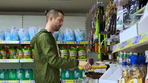 Buying ax in the hypermarket Stock Footage 142972701