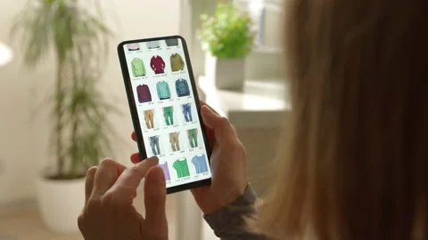 Buying clothes in the online store using the application in the smartphone.  Video stock 194741378