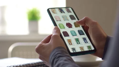 Buying clothes in the online store using the application in the smartphone.  Stock Footage 194840674