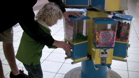 Buying gum from machine Stock Footage 10574287