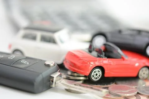 Buying or renting a car concept with car toys, car key, coins and bills Stock-Fotos